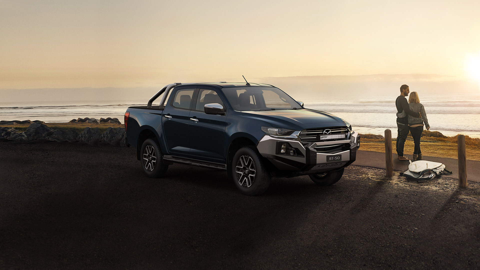 dark blue ute parked near ocean